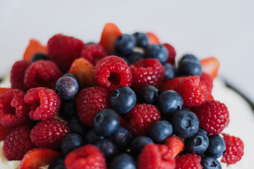 Tasty summer berry baiser pavlova cake with strawberries, raspberries and blueberries