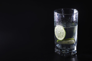 Lime water. Drinking water with fresh lime. Mineral water. Healthy, mineral-rich, refreshing water with lime.