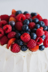 Tasty summer berry baiser pavlova cake with strawberries, raspberries and blueberries