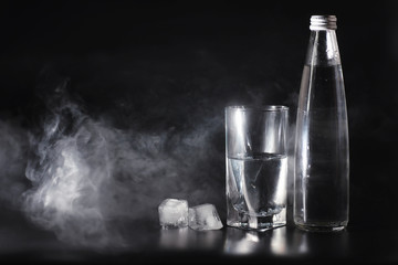 Close up pouring purified fresh drink water from the bottle on table in living room. Drinking water. Mineral vitamin water. Healthy, mineral-rich, refreshing water.