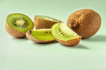 fresh juicy kiwi on a light green surface