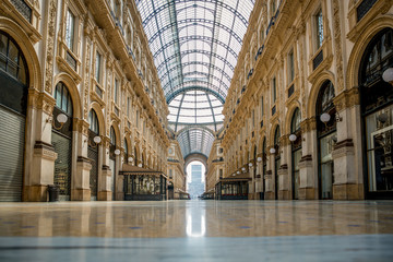 Naklejka premium Empty streets due to covid-19 virus. Lockdown in european town. Strange spring in Milan galleria Vittorio Emanuele Italy. Report from deserted cities people are locked up. Nobody can go out all closed