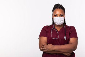 African american doctor in a medical mask over white background with copy space. Medicine, healthcare and people concept.