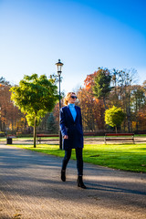 Middle-aged woman walking in city park