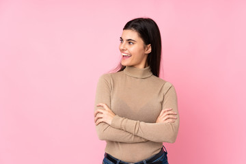 Fototapeta premium Young woman over isolated pink background happy and smiling