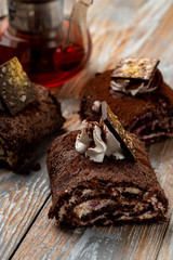 Seasonal chocolate roulade with whipped cream cheese and chocolate
