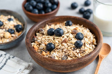 Healthy breakfast cereals muesli in bowl with fresh blueberries. Concept of clean eating, dieting, weight loss