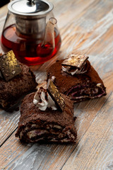 Close up of chocolate roulade with whipped cream cheese and chocolate