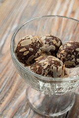 Rum balls of sponge biscuit, cocoa, rum and almonds in a glass bowl