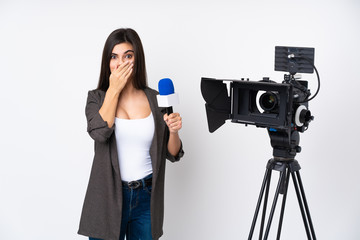 Reporter woman holding a microphone and reporting news over isolated white background with surprise facial expression