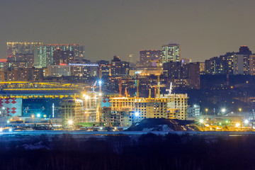 Night city. Construction of residential buildings in Moscow