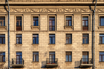 Fototapeta na wymiar Windows of old buildings in Saint Petersburg, background-symmetry in buildings. 