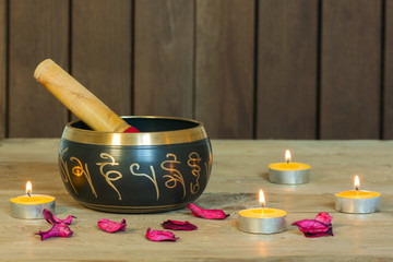 Studio shot of Tibetan singing bowls with burning candles