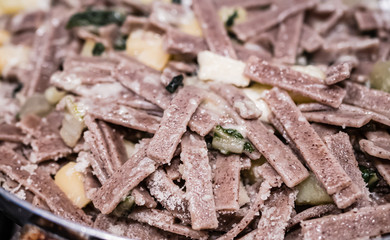 Close up of the succulent and typical Italian dish Pizzoccheri. Typical dish from Valtellina, Lombardy, Italy.