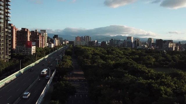 Taipei Taiwan, Aerial View on Daan Forest Park and Evening Traffic on Jianguo Road Under Sunset Sunlight