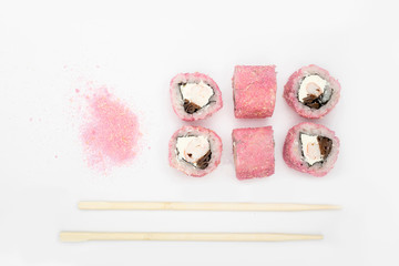 Japanese cuisine. Maki sushi. isolated on white background. Sushi rolls lie on a white background, top view, next to them are Japanese bamboo sticks. Concept idea for a japanese restaurant menu.
