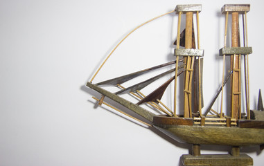 Close-up Ship of miniature hand made toy on rustic white background