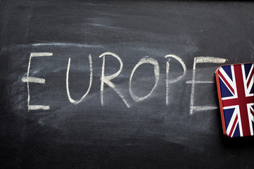 erasing europe, hand written word on blackboard being erased by UK flag, brexit concept
