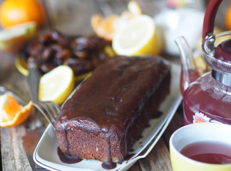 Food background.Homemade baking chocolate pumpkin muffin, iced on a wooden table with food.