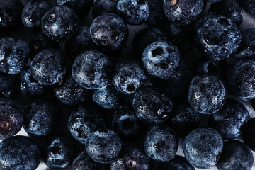 .Pattern with blueberries on a dark background. View from above. Vegetarian healthy food. Healthy breakfast. Natural background Fresh fruits.
