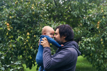 Bearded middle age dad holding baby.