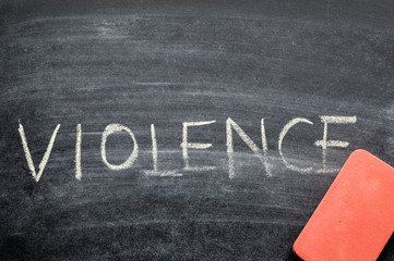 erasing violence, hand written word on blackboard being erased concept