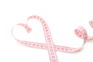 Measuring tape in the form of heart isolated on white background