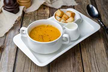 Soup cream of pumpkin on wooden table