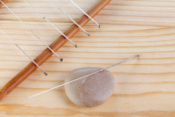 Table with needles for acupuncture. Silver needles for traditional acupuncture medicine on table.
