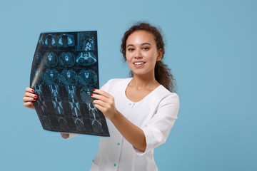 Smiling african american doctor woman in medical gown holding x-ray the brain by radiographic image...