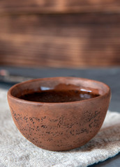 Ceramic bowl with fragrant tea on a linen towel.