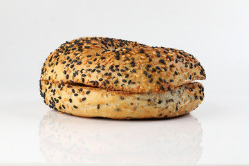 Toasted sliced black seed sesame bagel bread on white background