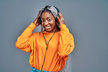 Image of happy young african lady standing isolated over gray background.