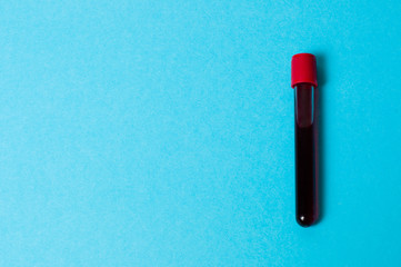 Test tube with blood isolate on a blue background
