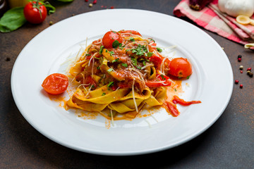 Pasta arabiata with tomatoes on white plate