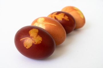 ZURICH, SWITZERLAND - APRIL 11, 2020:  Easter eggs, naturally colored with onion peels and prints of clover and dandelion leaves.