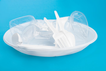 Social environmental issue. Plastic pollution of the planet. White plastic on a blue background. Ecological catastrophy. Sorting and processing of a stick. Plastic waste in the environment.Eco-problem