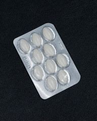 pills on black background