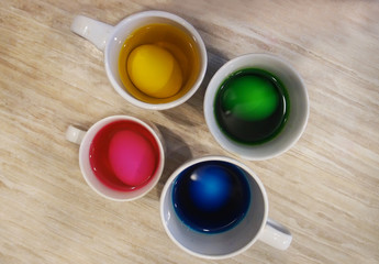 Staining eggs in a glass with food paint for Easter.          