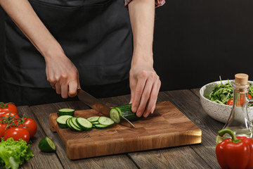 Woman cooking fresh vegetable salad. Female hands. Diet concept for healthy lifestyle with copyspace.