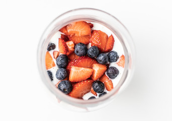 Delicious and natural glass with yogurt, oatmeal, strawberries, blueberries and milk all mixed...
