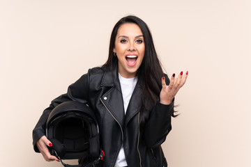 Young Colombian girl holding a motorcycle helmet over isolated background unhappy and frustrated with something