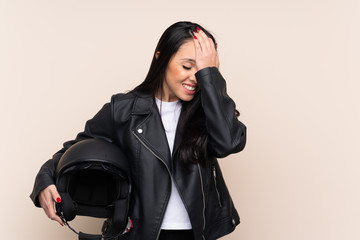 Naklejka na ściany i meble Young Colombian girl holding a motorcycle helmet over isolated background having doubts with confuse face expression