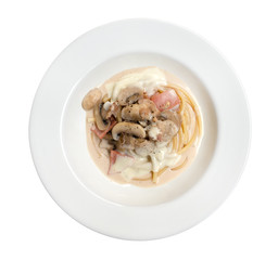 Italian pasta spaghetti carbonara with fried bacon in ceramic plate top view isolated on white background, clipping path included