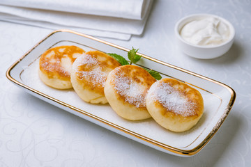 cheesecakes from cottage cheese on white table