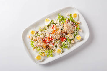 healthy salad in a white plate on a white background. Healthy eating