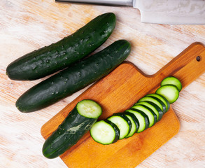 Chopped cucumbers on wooden background