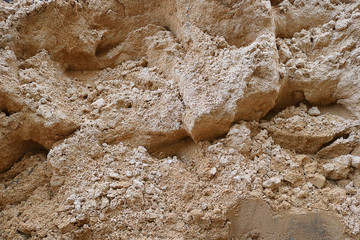 piled up light sand with little stones in irregular shape background