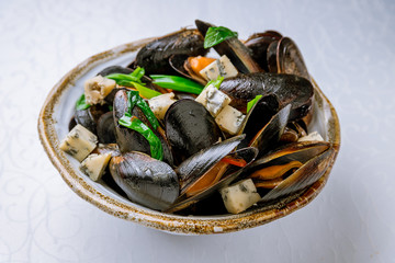 mussels in blue cheese sauce on white plate