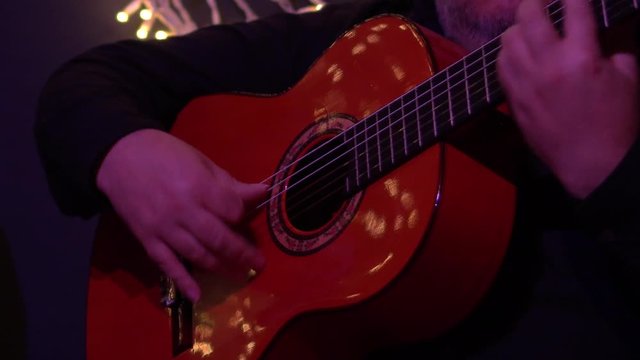 Flamenco guitar player, unrecognizable. Hands playing fast spanish melody.